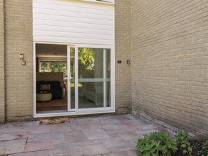 A residential building with a sliding glass door leading to a patio area. - 67 Manor Villas (St. Columb Major)