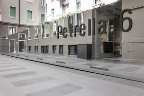 A modern building facade with the name 'Petrella' and the number '6' prominently displayed. - 8 Min walk from the station and Corso Buenos Aires (Milan)