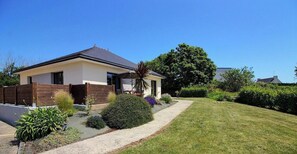 Ein modernes, zweistöckiges Haus mit gepflegtem Rasen und Garten.