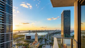 A high-rise building with a view of a cityscape, including a bridge and water body. - Luxury 2BR Sky Retreat Best Miami Bay Views (Miami)