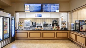 A cafe with a menu board, coffee machines, and a display of pastries. - Relaxing Las Vegas Escape with Spacious 3BR Resort Accommodations (Las Vegas)