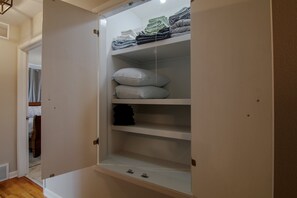 A walk-in closet with shelves for folded clothes and storage bins. - Truman Lake Country Home: Circle Drive for Boats/Trailers & Family Friendly (Clinton)