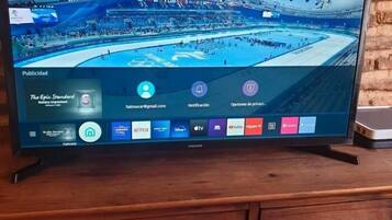 A television displaying a Eurosport channel with a view of a large indoor stadium.