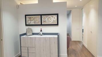 A modern bathroom with a vanity, a mirror, and two framed abstract paintings on the wall.