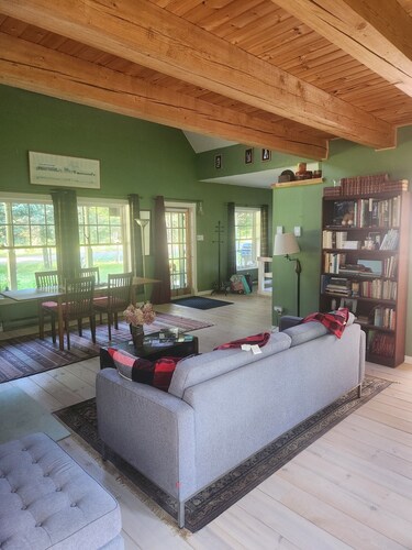 A small, rustic cabin surrounded by trees, with access to an alpaca farm!