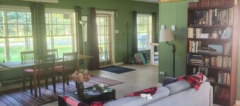 A small, rustic cabin surrounded by trees, with access to an alpaca farm!