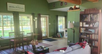 A small, rustic cabin surrounded by trees, with access to an alpaca farm!