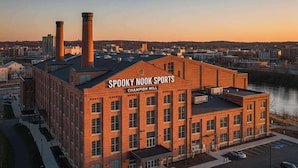 Ein Backsteinhaus mit der Aufschrift 'Spooky Nook Sports Champion Mill' bei Sonnenuntergang.