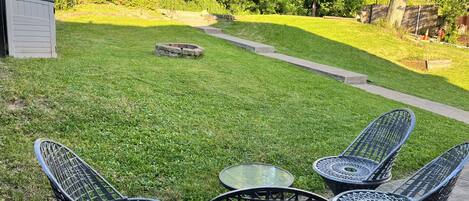 A patio area with outdoor furniture and a lawn.