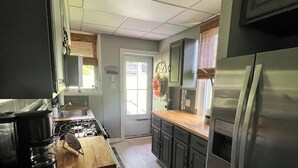 A kitchen with a stove, refrigerator, and wooden countertop. - This is the Pittsburgh View-Mt. Washington Skyline Escape! (Pittsburgh)