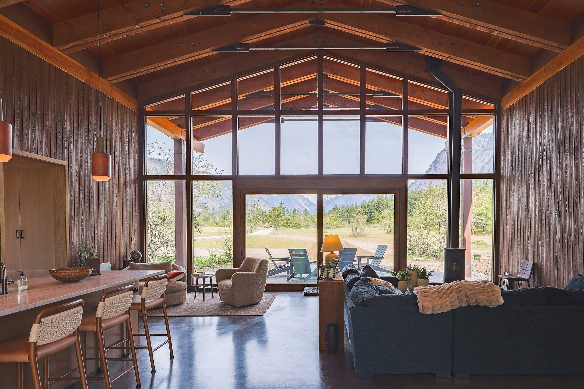 Open-plan living and kitchen with floor-to-ceiling mountain views