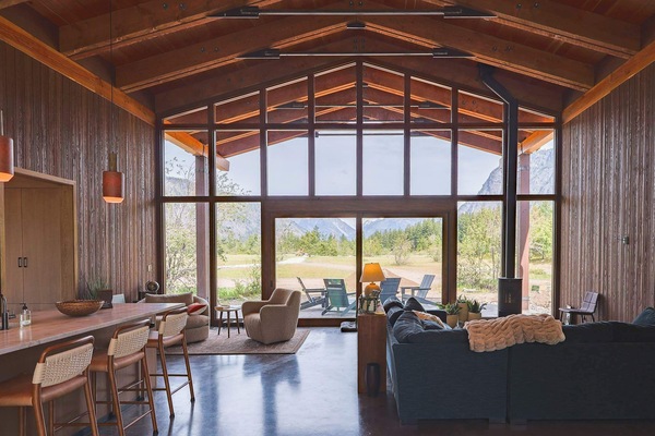 Open-plan living and kitchen with floor-to-ceiling mountain views