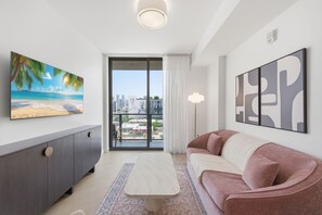 A modern living room with a sofa, a coffee table, a cabinet, and artwork on the walls. - Boutique Wynwood Residences (Miami)