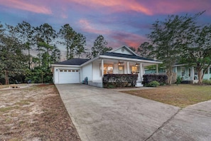 A single-story house with a garage, a covered porch, and a well-maintained lawn. - Dog-Friendly 30A Home | Sleeps 8 | Fire Pit Yard (Santa Rosa Beach)