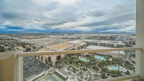A cityscape with a large building complex, a parking area, and a pool. - 1BD/2BA • Balcony • No Resort Fee • Free Parking E25D1 (Las Vegas)
