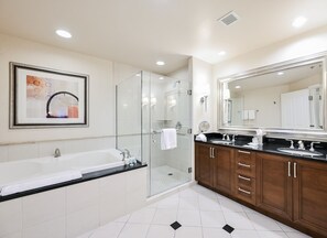 A modern bathroom with a glass-enclosed shower, a large mirror, and a dual sink vanity. - PH Floor Studio • Strip View • Balcony • No Resort Fee D29P3 (Las Vegas)