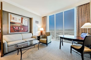 A hotel room with a large window, a sofa, a small table, and a lamp. - Studio • No Resort Fee • Free Parking A35G3 (Las Vegas)