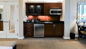 A compact kitchen with a microwave, toaster, and dishwasher. - SVS: Strip View Studio | Signature at MGM (Las Vegas)