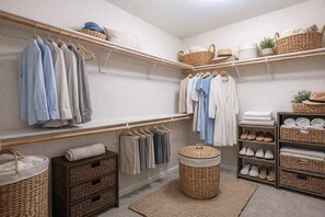 A neatly organized closet with hanging clothes, shelves, and storage baskets. - 2 BR Layout with Bonus Room • Quiet + Parking (Carson City)