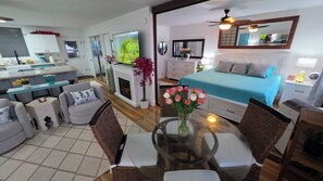 Ein modernes Hotelzimmer mit Bett, Essbereich, Küche und Wohnbereich.