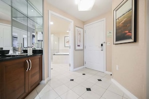A hallway with a kitchen area, a bathroom, and a door leading to another room. - Studio • No Resort Fee • Free Parking A3B1 (Las Vegas)