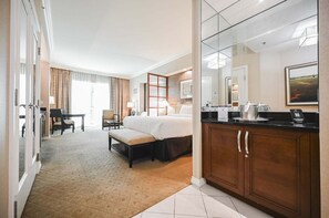 A hotel room with a bed, a desk, a chair, a sofa, a bathroom with a mirror, and a coffee maker. - PH Floor Studio • Strip View • Balcony • No Resort Fee D35P2 (Las Vegas)