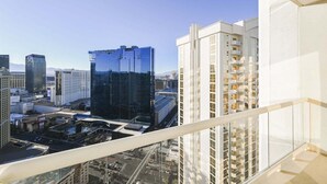 A high-rise hotel with a modern glass facade, multiple balconies, and a view of the surrounding cityscape. - SVS: PH Floor Strip View Balcony | Signature at MGM (Las Vegas)