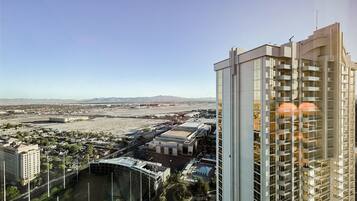 A high-rise hotel with a modern design, featuring multiple balconies and a view of the surrounding cityscape.