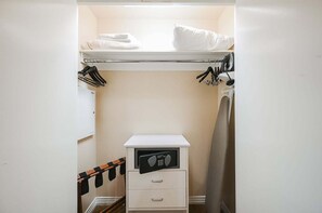 A compact storage closet with a hanging rack, a small drawer unit, and a built-in heater. - SVS: Sphere Strip View Balcony | Signature at MGM (Las Vegas)