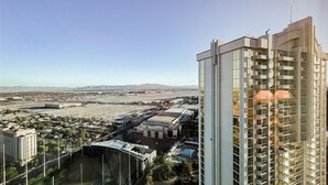 A high-rise hotel with a modern design, featuring multiple balconies and a view of the surrounding cityscape. - SVS: Strip View Studio | Signature at MGM (Las Vegas)