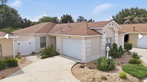 A single-story house with a garage, a driveway, and a well-maintained garden.