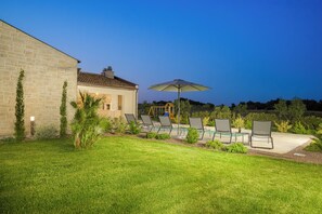 A stone building with a patio area featuring outdoor seating and a pool. - Villa ViriBora (Istria - Loborika) (Loborika)