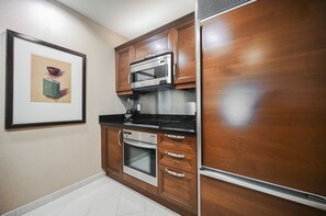 A kitchen with wooden cabinets, a microwave, an oven, and a blender. - 1BD/2BA • Strip View • Balcony • No Resort Fee F2Q2 (Las Vegas)