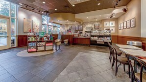 A bakery with a central counter, seating area, and display cases. - SVS: One Bedroom | Strip View Balcony | MGM Signature (Las Vegas)