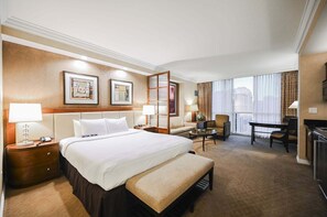 A hotel room with a large bed, a desk, a chair, and a view of the city. - Strip View Studio • No Resort Fee • Free Parking B2O1 (Las Vegas)