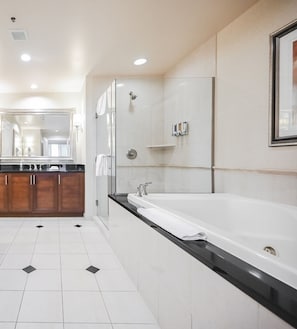A modern bathroom with a large bathtub, a glass shower enclosure, and a vanity with a mirror. - SVS: One Bedroom | Balcony | Signature at MGM (Las Vegas)
