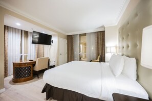 A hotel room with a large bed, a desk with a chair, a television, and a mirror. - 1BD/2BA • Strip View • Balcony • No Resort Fee F22K3 (Las Vegas)