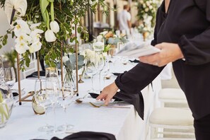 A table set with white tablecloths, glassware, and floral centerpieces. - Intercontinental Dominica Cabrits Resort & Spa, an IHG Hotel (Portsmouth)