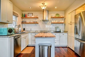 A modern kitchen with white cabinets, stainless steel appliances, and wooden countertops. - Lake Anna A-Frame | Beach, Dock & Hot Tub | 5BR (Bumpass)