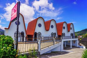 A building with a distinctive architectural style, featuring multiple arched windows and a red roof.