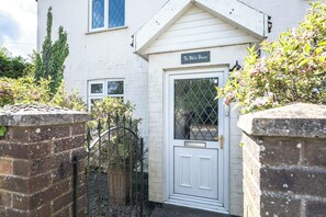A white building with a sign reading 'The White House,' a gated entrance, and a small window. - The White House, Tunstall (Tunstall, Woodbridge)
