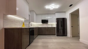 A modern kitchen with a central island, built-in microwave, and stainless steel refrigerator. - luxury cozy apartment for couples only (Hallandale Beach)