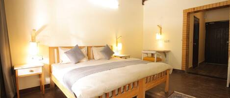 A bedroom with a wooden bed, bedside tables, and wall-mounted lamps.