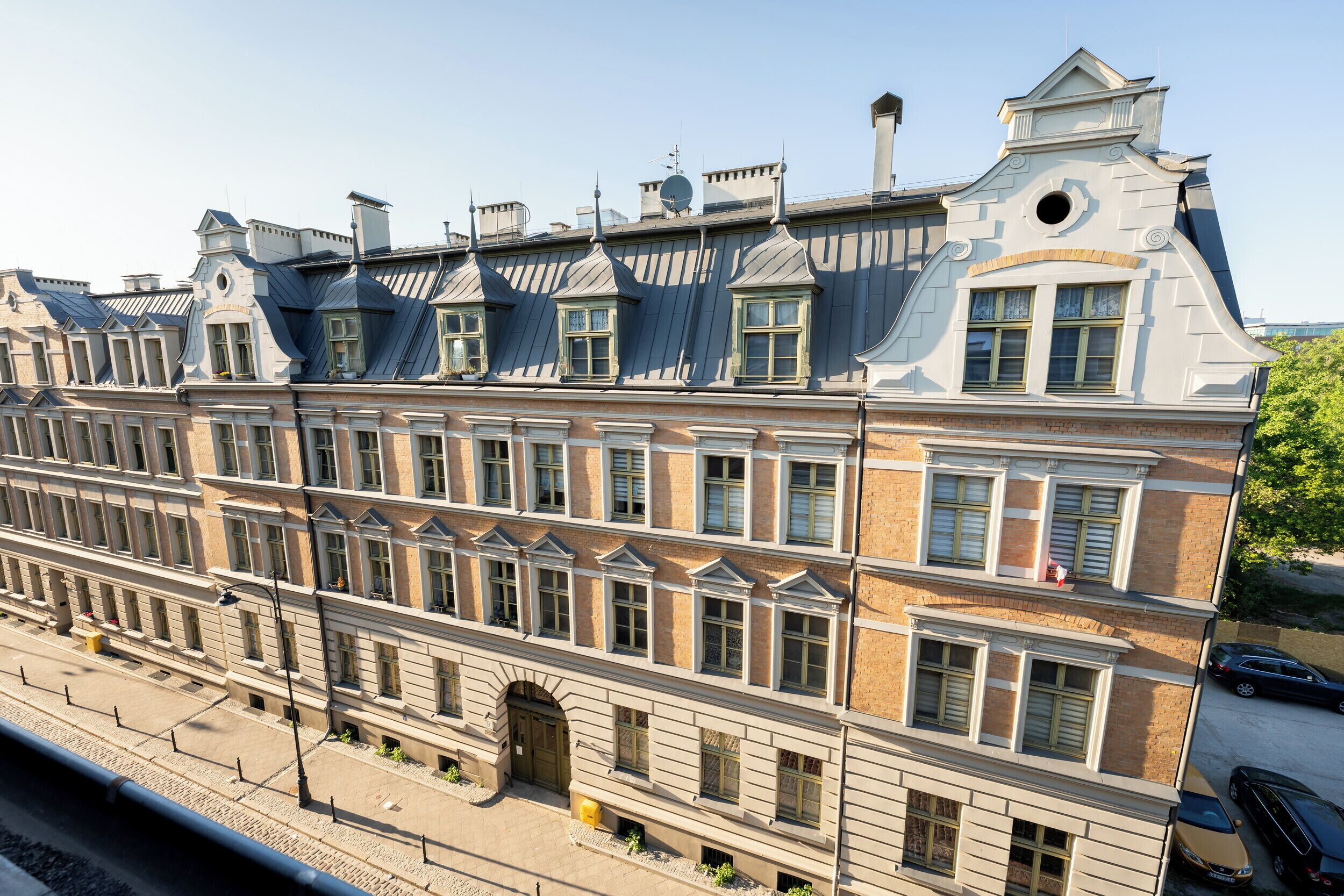 A multi-story building with a classic architectural style, featuring symmetrical windows and a central entrance.