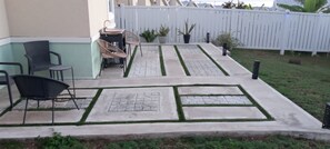 A patio with outdoor furniture, a small table, and a white fence. - OCEANCOMFORT. (Lucea)