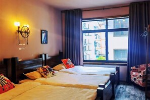 A hotel room with two beds, a large window with a city view, and a wall-mounted light fixture. - Jiuqi Zhangjiajie Yunqin Boutique Inn (National Forest Park Wulingyuan Biaozhimen) (Zhangjiajie)