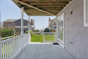 A covered porch with a wooden ceiling, white railings, and a view of the ocean. - Amazing Beach House with Ocean Views - Just steps to Wells Beach (Wells)