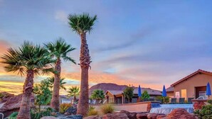 A resort with palm trees, a pool, and a mountain backdrop. - Zion-View Retreat: Luxury House w/ Pool & Hot Tub (Santa Clara)