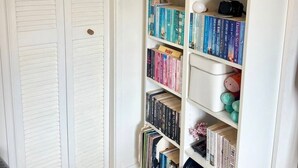 Uma estante com vários livros e uma pequena planta.