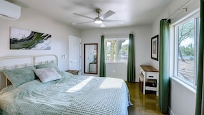 A bedroom with a bed, a ceiling fan, a window with curtains, and a desk. - Saguaro Grove, Built May '26, Smart Lock, Quiet Cul-de-sac (Tucson)
